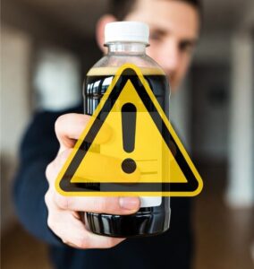 bottle of syrup with a caution sign overlay