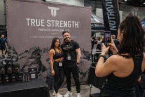 fitness expo booth with a large branded fabric backdrop